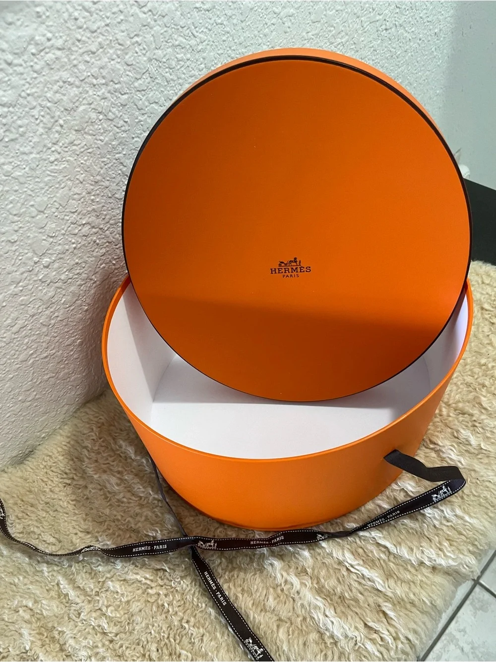 Original Hermès Orange Round Hat Box with branded brown ribbon